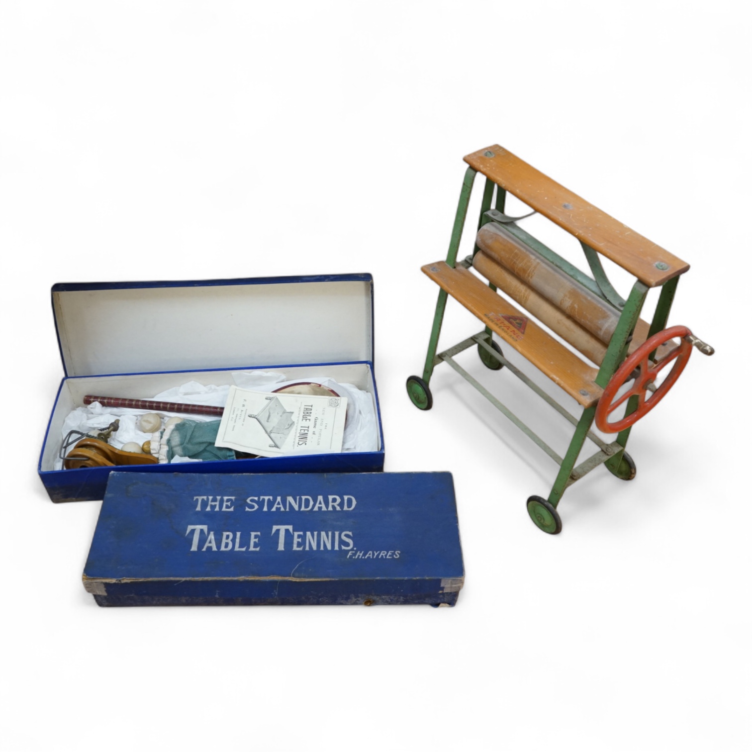 Two boxed 1930s F.H. Ayres table tennis sets together with a Tri-ang wood and steel toy mangle, height 50cm. Condition - fair to good.